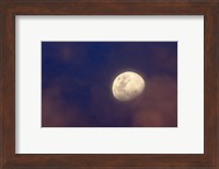 The moon between colorful clouds at sunset Fine Art Print