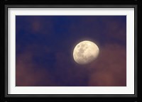 The moon between colorful clouds at sunset Fine Art Print