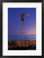 Venus and Jupiter are visible behind an old farm water pump windmill, Alberta, Canada Fine Art Print