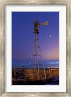 Venus and Jupiter are visible behind an old farm water pump windmill, Alberta, Canada Fine Art Print