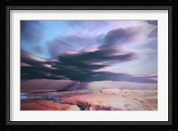 A swift moving thunderstorm moves over a desert landscape Fine Art Print