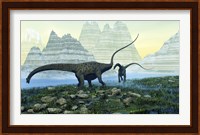 Diplodocus dinosaurs munch on vegetation near a mountain lake Fine Art Print