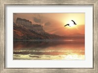Two Bald Eagles fly along a mountainous coastline at sunset Fine Art Print
