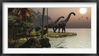 Two Brachiosaurus dinosaurs enjoy a beautiful sunset Framed Print