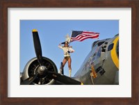 1940's style majorette pin-up girl on a B-17 bomber with an American flag Fine Art Print
