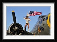 1940's style majorette pin-up girl on a B-17 bomber with an American flag Fine Art Print
