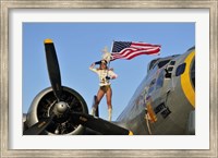 1940's style majorette pin-up girl on a B-17 bomber with an American flag Fine Art Print