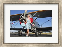 Elegant 1940's style pin-up girl standing in front of an F3F biplane Fine Art Print