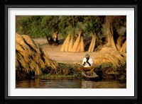 Local Man Fishing and Piles of Straw for Hatch, Okavango Delta, Botswana Fine Art Print