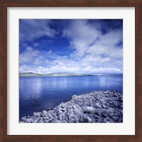 Tranquil lake and rocky shore against cloudy sky, Sardinia, Italy Fine Art Print