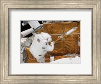 Astronaut works with the Hubble Space Telescope in the cargo bay of Atlantis Fine Art Print