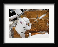 Astronaut works with the Hubble Space Telescope in the cargo bay of Atlantis Fine Art Print