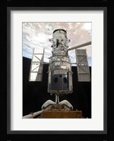 The Space Shuttle Atlantis' arm lifts the Hubble Space Telescope from the cargo bay Fine Art Print