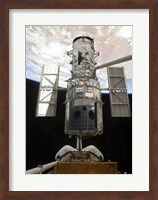 The Space Shuttle Atlantis' arm lifts the Hubble Space Telescope from the cargo bay Fine Art Print