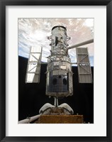 The Space Shuttle Atlantis' arm lifts the Hubble Space Telescope from the cargo bay Fine Art Print