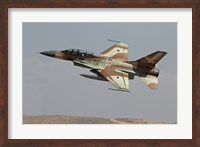 An F-16B Netz of the Israeli Air Force in flight over Israel Fine Art Print