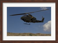 An AH-1F Tzefa of the Israeli Air Force flying over the Golan Heights, Israel Fine Art Print