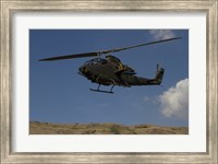 An AH-1F Tzefa of the Israeli Air Force flying over the Golan Heights, Israel Fine Art Print
