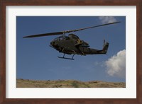 An AH-1F Tzefa of the Israeli Air Force flying over the Golan Heights, Israel Fine Art Print