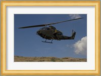 An AH-1F Tzefa of the Israeli Air Force flying over the Golan Heights, Israel Fine Art Print