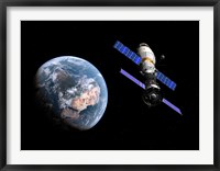 A manned Soyuz TMA-M spacecraft docked with an extended stay module Fine Art Print