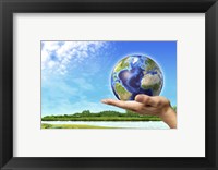 Human Hand Holding Earth Globe with a Green Landscape Background Fine Art Print
