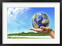 Human Hand Holding Earth Globe with a Green Landscape Background Fine Art Print