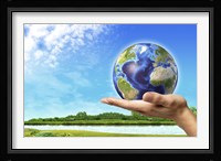 Human Hand Holding Earth Globe with a Green Landscape Background Fine Art Print