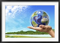 Human Hand Holding Earth Globe with a Green Landscape Background Fine Art Print