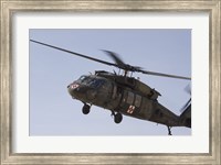 A UH-60 Blackhawk Medivac helicopter flies over Camp Warhorse Fine Art Print