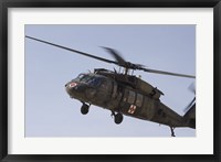 A UH-60 Blackhawk Medivac helicopter flies over Camp Warhorse Fine Art Print