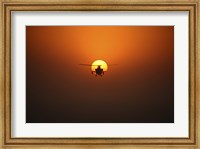 An AH-64D Apache Helicopter Flying into the Sun over Iraq Fine Art Print