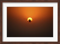 An AH-64D Apache Helicopter Flying into the Sun over Iraq Fine Art Print