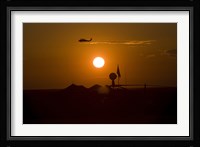 UH-60 Blackhawk Flies Over Camp Speicher Airfield at Sunset Fine Art Print