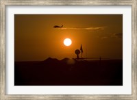 UH-60 Blackhawk Flies Over Camp Speicher Airfield at Sunset Fine Art Print