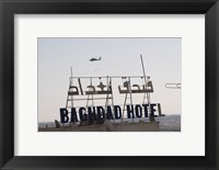 An AH-64 Apache in flight over the Baghdad Hotel in central Baghdad, Iraq Fine Art Print