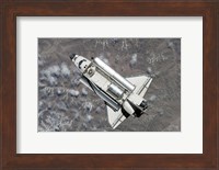 Aerial view of Space Shuttle Discovery over Earth as it approaches the International Space Station Fine Art Print