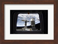 Two Russian Spacecraft Docked with the International Space Station, as seen from Space Shuttle Discovery's Flight Deck Window Fine Art Print