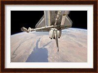 The Aft Section of the Docked Space Shuttle Discovery and the Station's Robotic Canadarm2 Fine Art Print