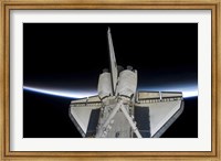 Space Shuttle Discovery Intersecting the Thin line of Earth's Atmosphere, while Docked with the International Space Station Fine Art Print