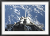 A partial view of Space Shuttle Atlantis Backdropped by a Blue and White Earth Fine Art Print