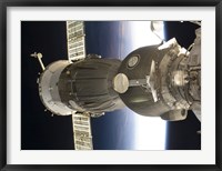 A Soyuz spacecraft backdropped by Earth Fine Art Print