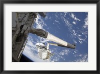 The Integrated Cargo Carrier in the grasp of the shuttle's remote manipulator system arm Fine Art Print