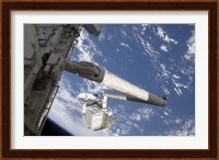 The Integrated Cargo Carrier in the grasp of the shuttle's remote manipulator system arm Fine Art Print