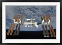 The International Space Station, Backdropped by the blackness of space and Earth's horizon Fine Art Print