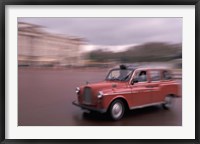 Cab racing past Buckingham Palace, London, England Fine Art Print