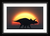 A Silhouetted Triceratops strolling Past a Setting Sun Fine Art Print