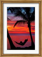 Woman in hammock, and palm trees at sunset, Fiji Fine Art Print