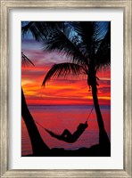 Woman in hammock, and palm trees at sunset, Fiji Fine Art Print