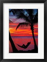 Woman in hammock, and palm trees at sunset, Fiji Framed Print